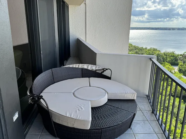 a living room with furniture and a floor to ceiling window