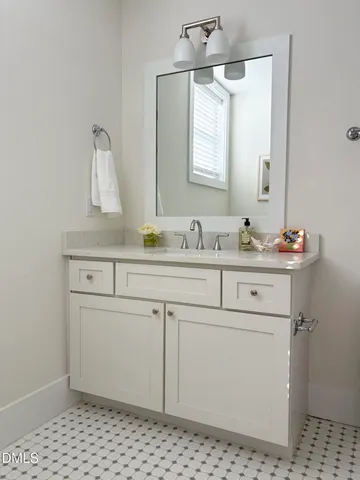 a bathroom with a sink toilet and mirror