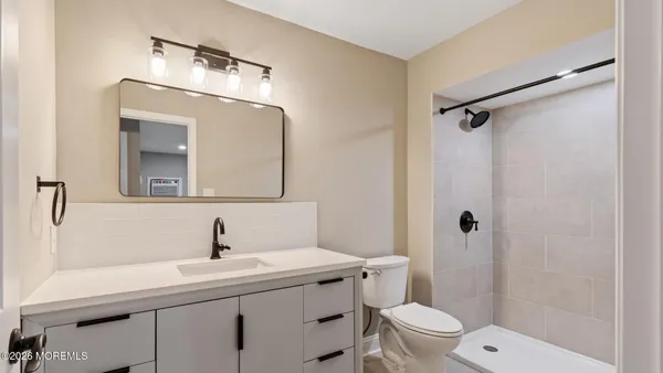 a bathroom with a sink toilet and shower