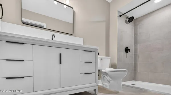 a bathroom with a shower a toilet and sink