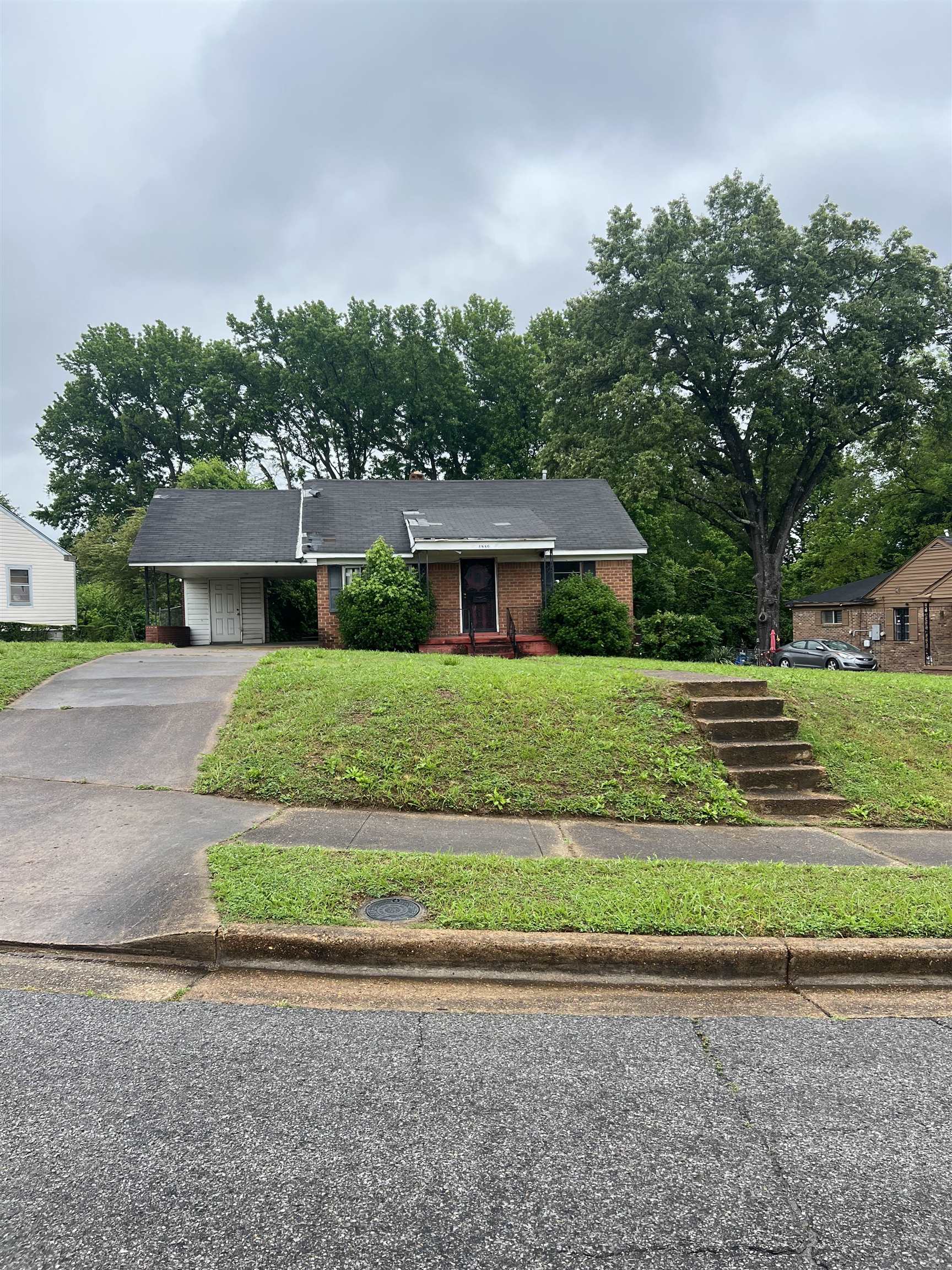 1880 Glory Circle Memphis, TN 38114 - Photo 2 of 3 a front view of a house with a yard