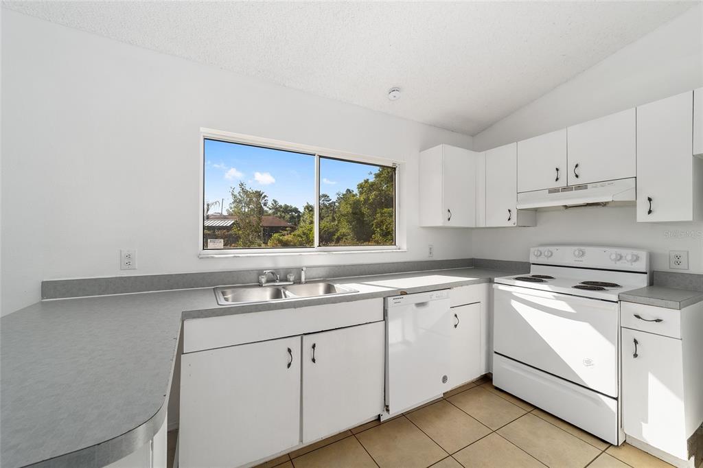 8 Ash Pass Run Ocala, FL 34472 - Photo 18 of 33 a kitchen with white cabinets appliances a sink and a window