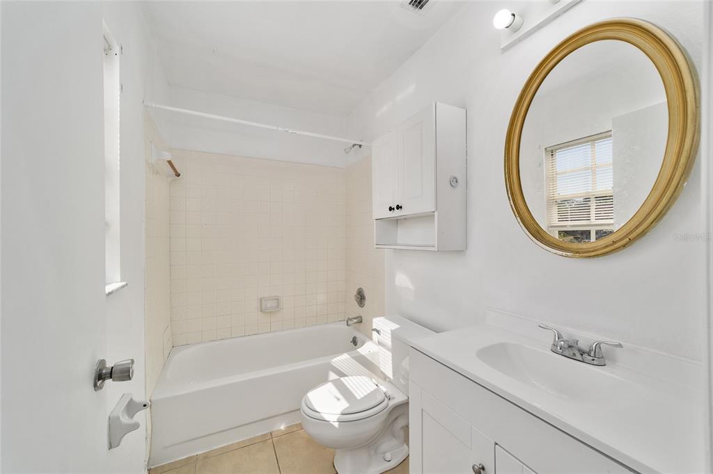8 Ash Pass Run Ocala, FL 34472 - Photo 21 of 33 a bathroom with a sink a toilet and a mirror