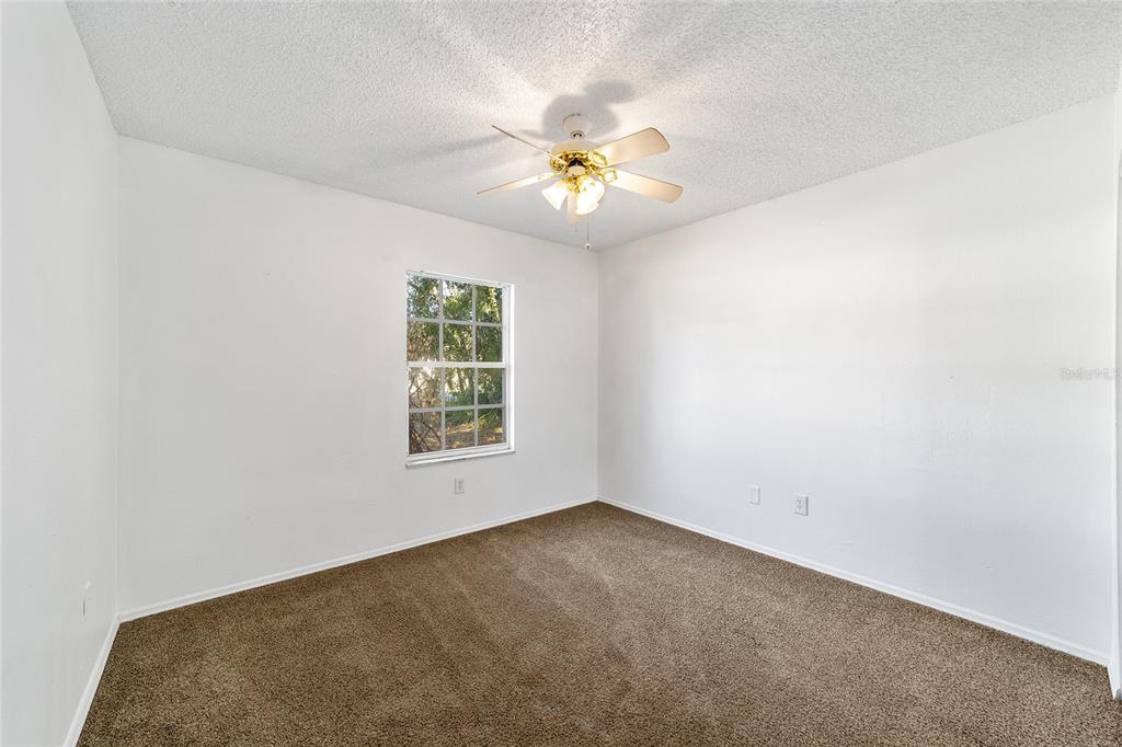 8 Ash Pass Run Ocala, FL 34472 - Photo 22 of 33 an empty room with a window and a fan