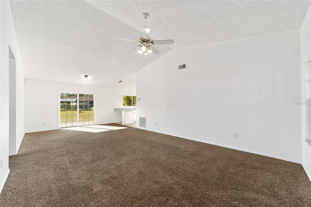 8 Ash Pass Run Ocala, FL 34472 - Photo 5 of 33 a view of an empty room with window and chandelier fan