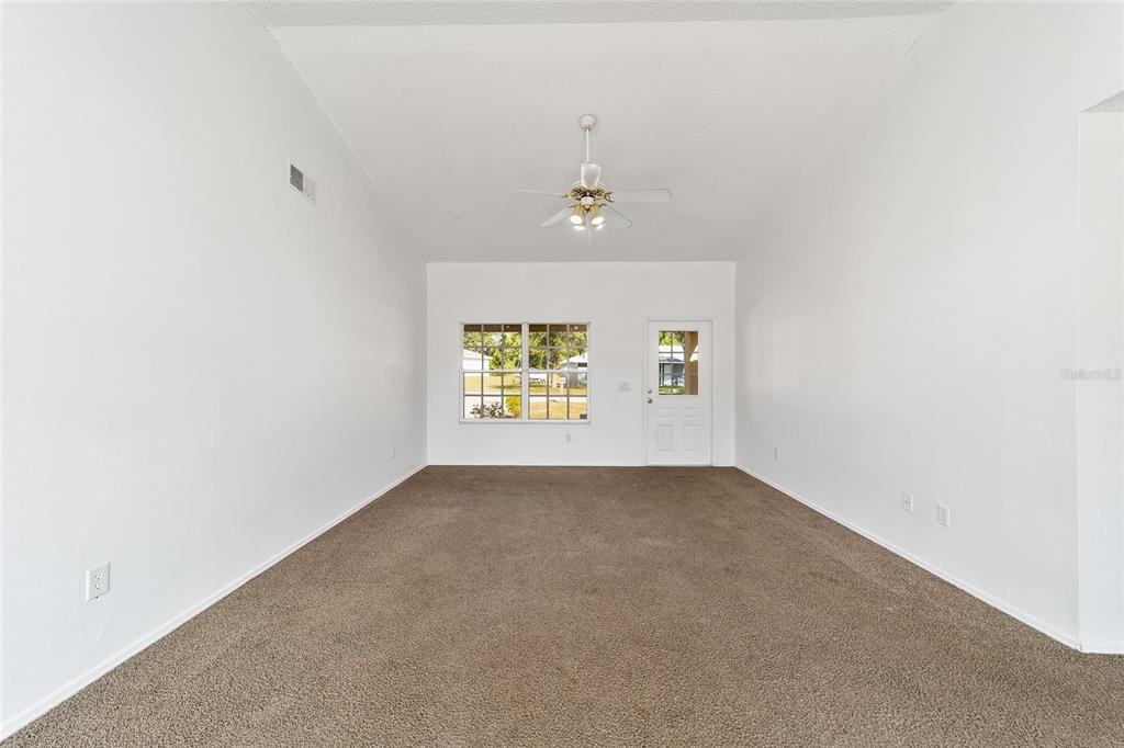 8 Ash Pass Run Ocala, FL 34472 - Photo 7 of 33 an empty room with windows and ceiling fan