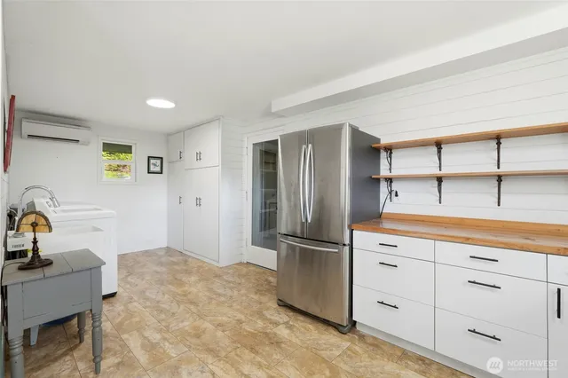 a kitchen with kitchen island a refrigerator and cabinets