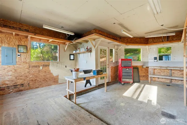 a bedroom with furniture and a large window