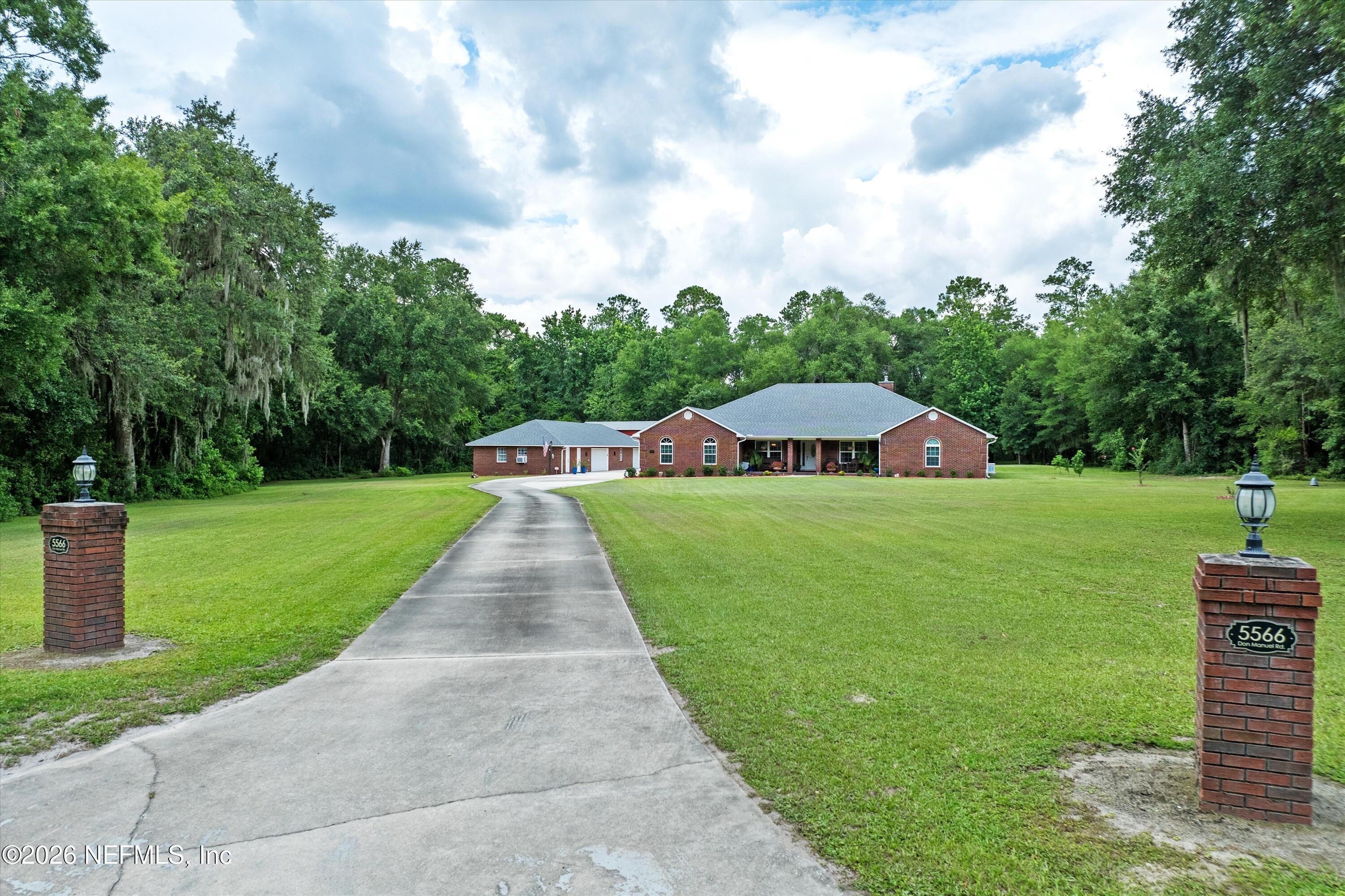 5566 Don Manuel Road Elkton, FL 32033 - Photo 2 of 47 a front view of a house with garden