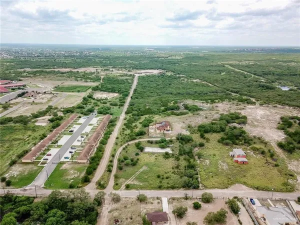 an aerial view of residential houses with outdoor space
