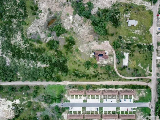 an aerial view of a house with a yard