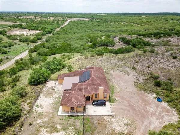 an aerial view of a house with a yard