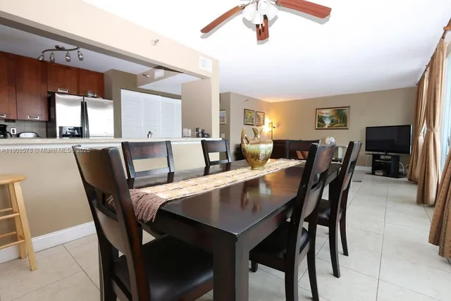 a view of a dining room with furniture and a chandelier