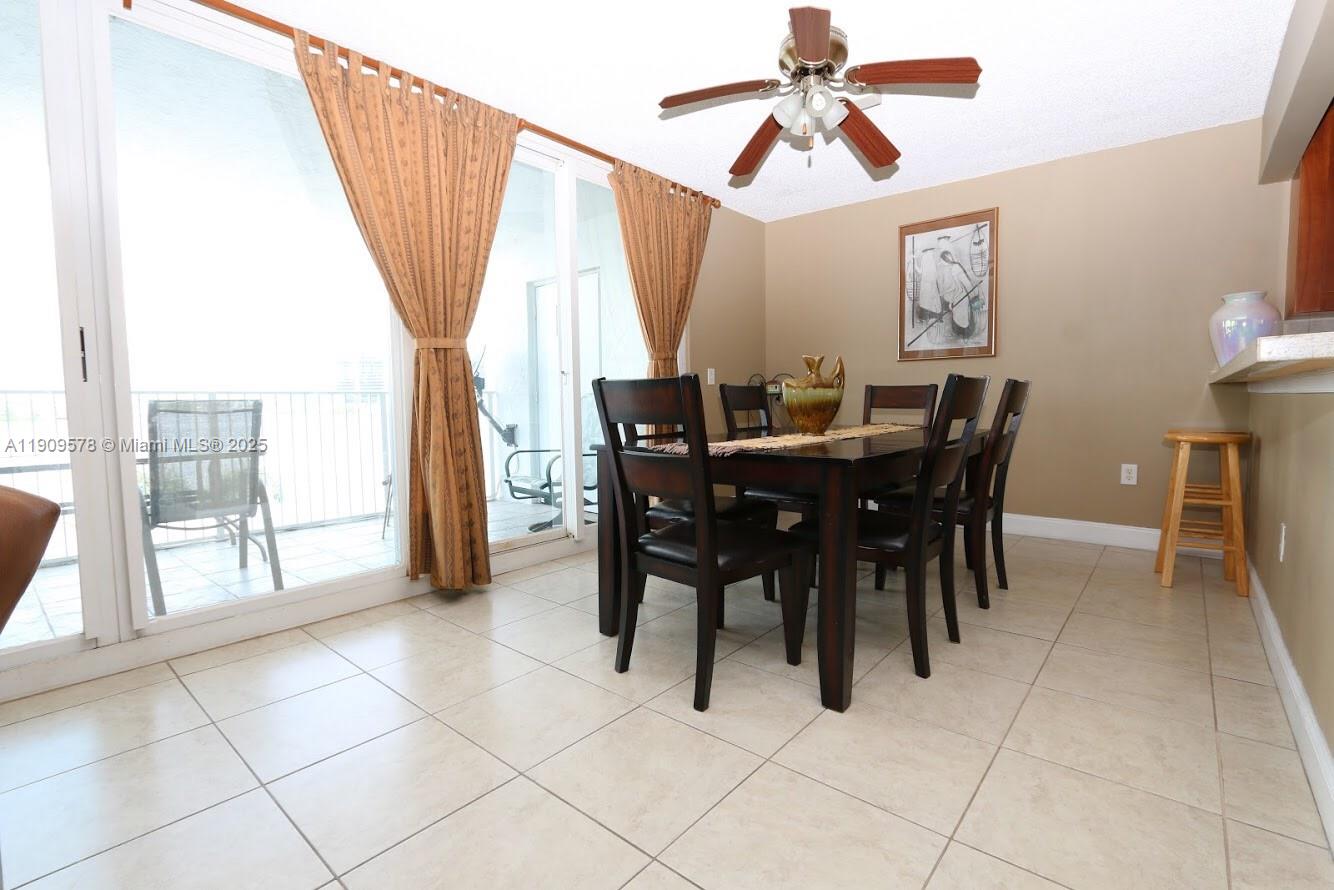 17800 North Bay Road, Unit 404 Sunny Isles Beach, FL 33160 - Photo 12 of 36 a view of a dining room with furniture and a chandelier