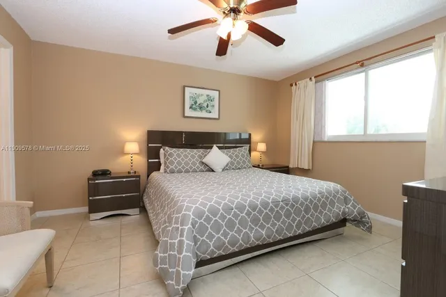 a bedroom with a large bed and a flat tv screen