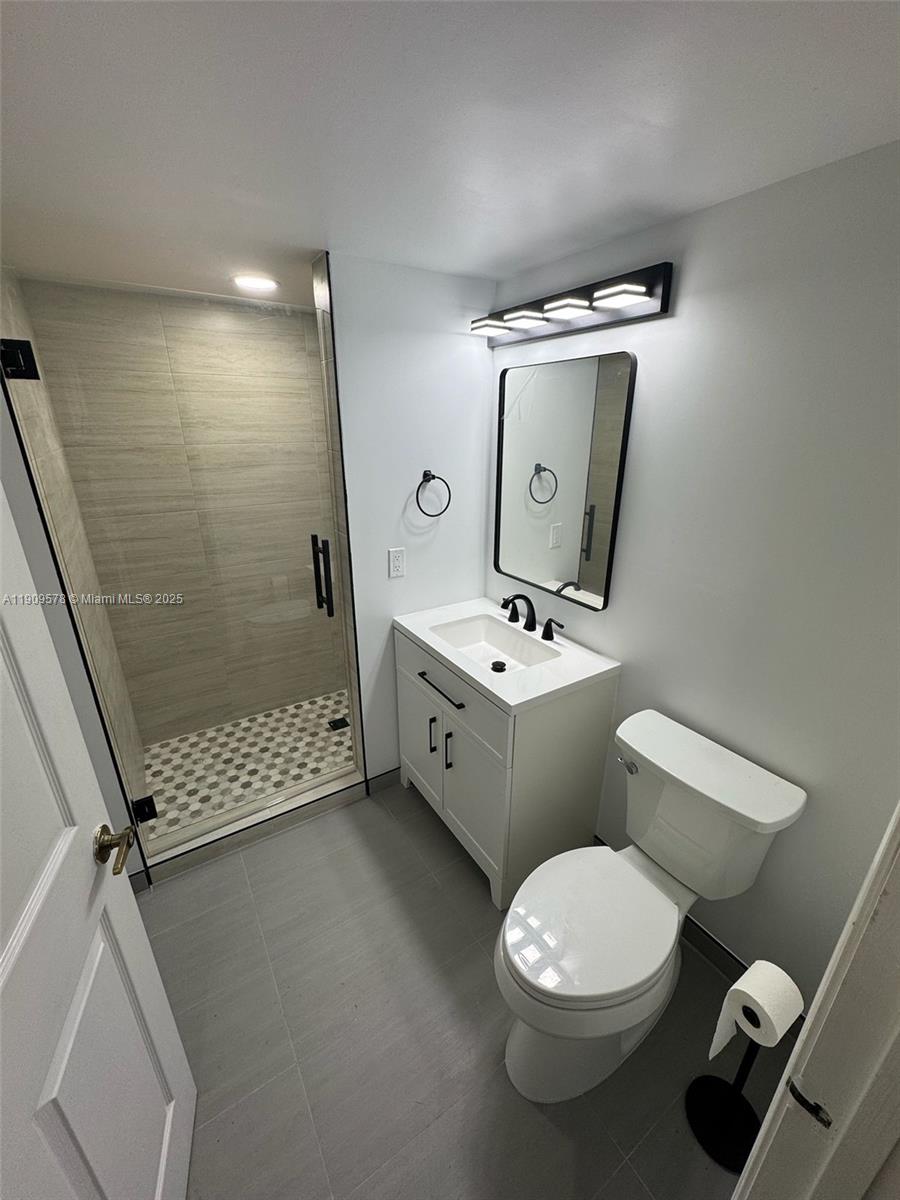 17800 North Bay Road, Unit 404 Sunny Isles Beach, FL 33160 - Photo 19 of 36 a bathroom with a toilet sink and mirror