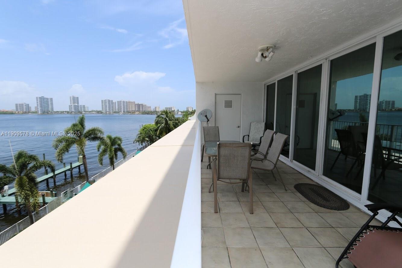 17800 North Bay Road, Unit 404 Sunny Isles Beach, FL 33160 - Photo 22 of 36 a view of a swimming pool with outdoor seating and plants