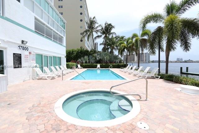 17800 North Bay Road, Unit 404 Sunny Isles Beach, FL 33160 - Photo 28 of 36 a view of a swimming pool with a lounge chair