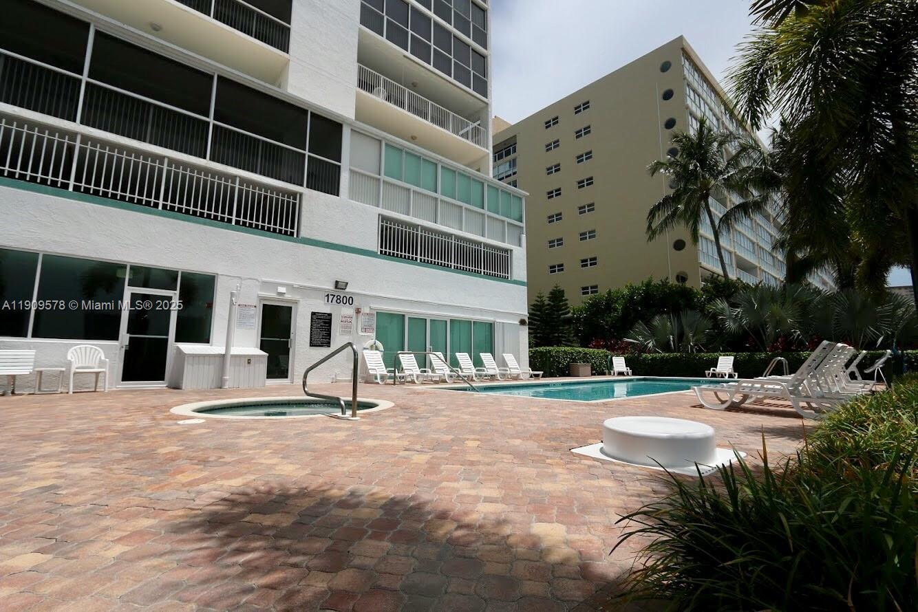 17800 North Bay Road, Unit 404 Sunny Isles Beach, FL 33160 - Photo 32 of 36 a house with palm tree in front of it