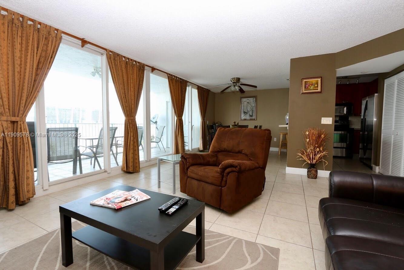 17800 North Bay Road, Unit 404 Sunny Isles Beach, FL 33160 - Photo 7 of 36 a living room with furniture and a window