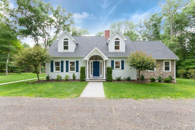 4041 Congress Street Fairfield, CT 06824 - Photo 1 of 1 a front view of a house with a garden