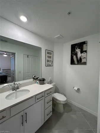 a bathroom with a double vanity sink toilet and a mirror