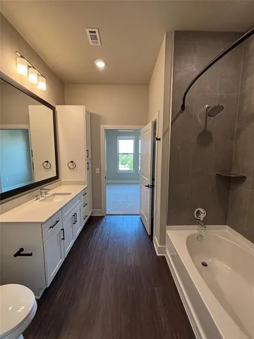 a bathroom with a double vanity sink and mirror with shower