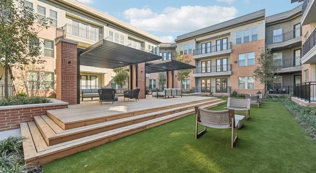a view of a house with a chairs and bench in a patio