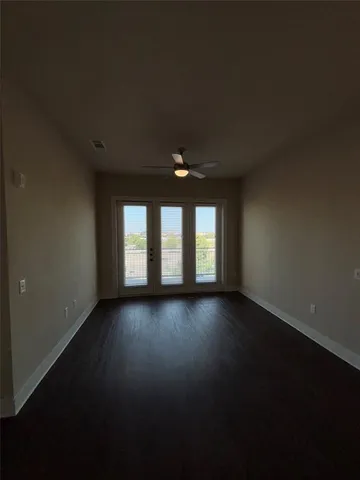 a view of wooden floor and windows in an empty room