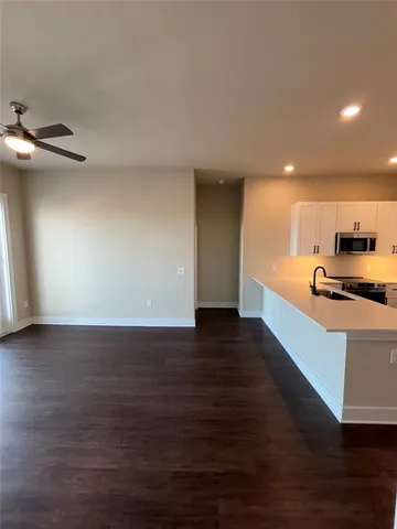 a view of kitchen with microwave and wooden floor