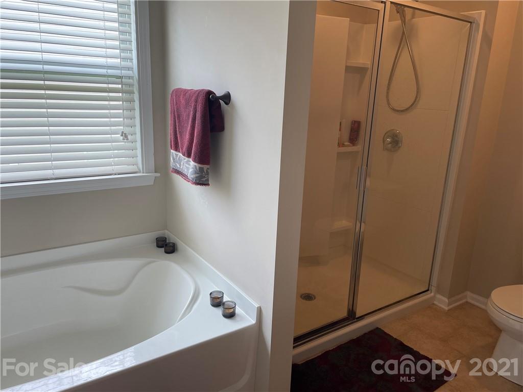 8097 Bryson Road Indian Land, SC 29707 - Photo 22 of 26 a bathroom with a tub and shower