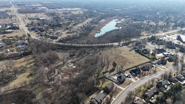 a view of a yard with wooden fence