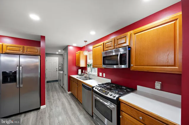 a kitchen with stainless steel appliances granite countertop a stove and a refrigerator