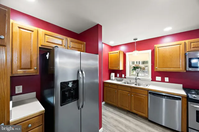 a kitchen with stainless steel appliances a sink stove and refrigerator