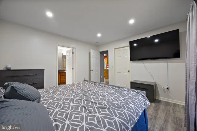 a bedroom with a bed and a flat screen tv