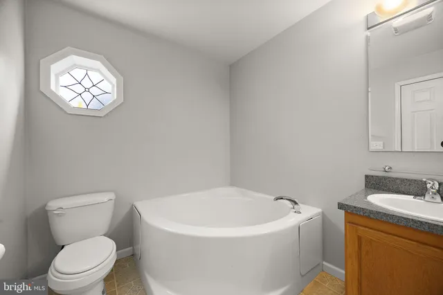 a white toilet sitting next to a bathroom sink