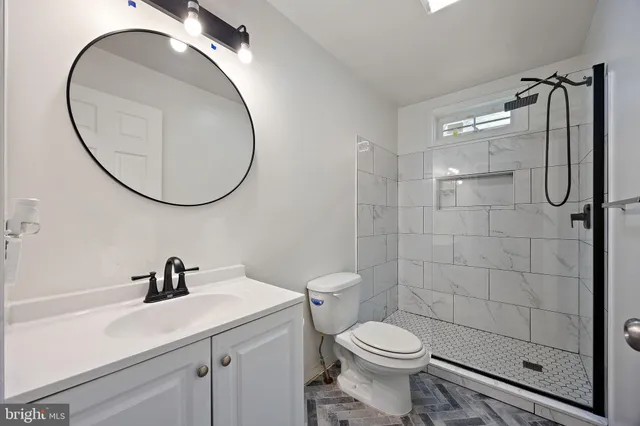 a bathroom with a sink toilet and a mirror