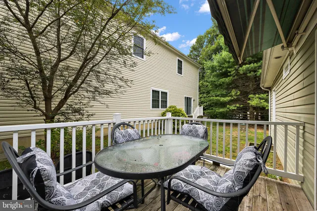 a view of a chair and table in the balcony