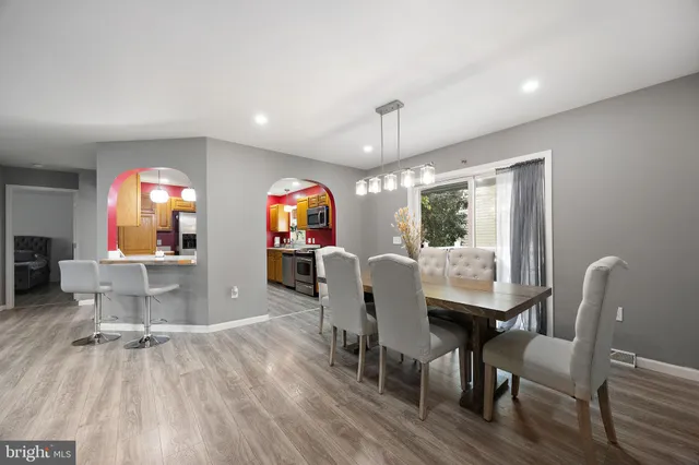 a dining room with furniture and wooden floor