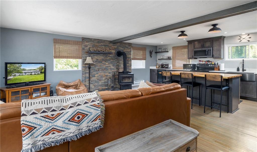 The island and kitchen area flow easily from the living and dining area.  Natural light pours in from the windows and is accented by the soft hues of color.