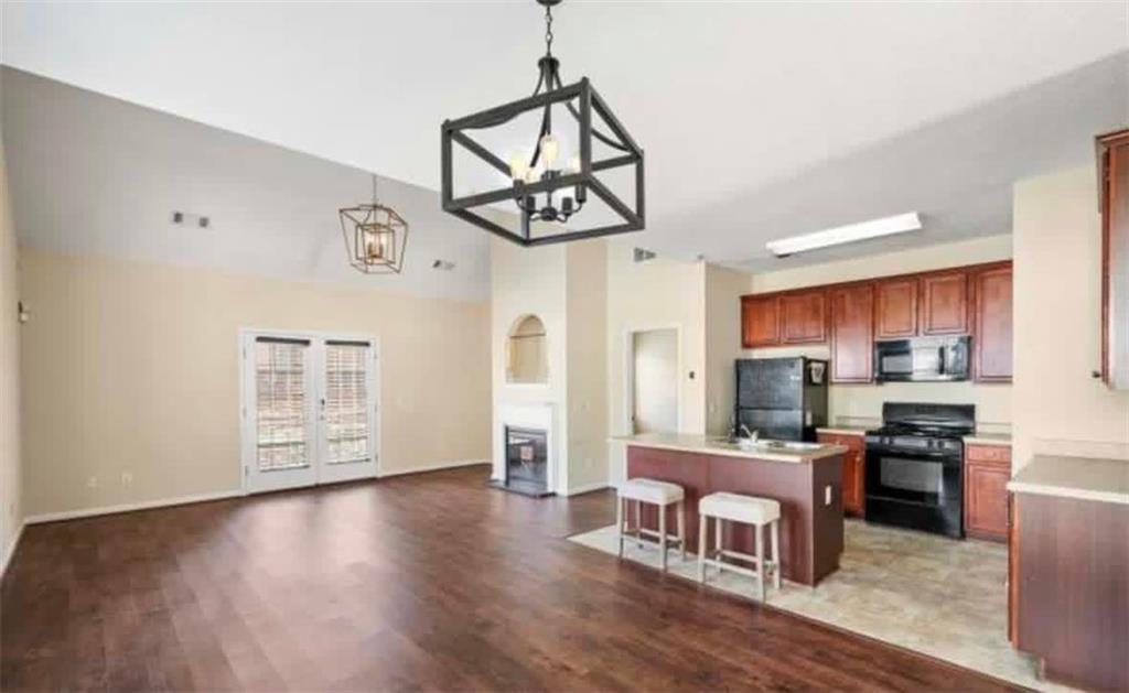 2162 Capella Circle Southwest Atlanta, GA 30331 - Photo 3 of 11 a living room with stainless steel appliances kitchen island hardwood floor and a view of kitchen