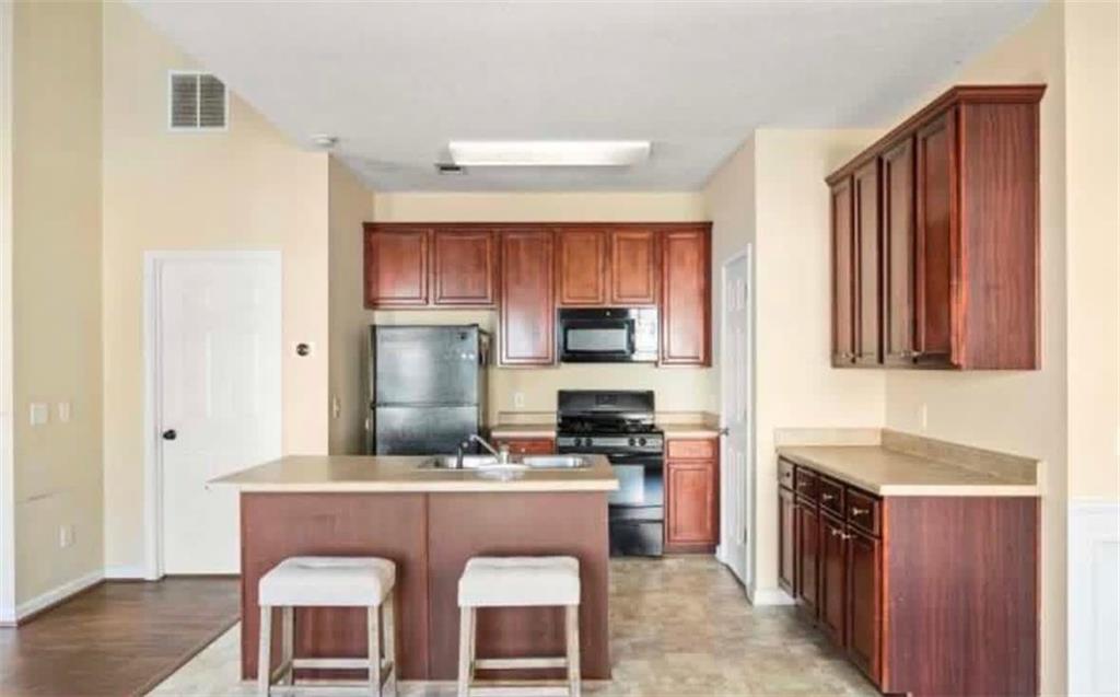 2162 Capella Circle Southwest Atlanta, GA 30331 - Photo 4 of 11 a kitchen with stainless steel appliances granite countertop a stove a sink dishwasher and a refrigerator