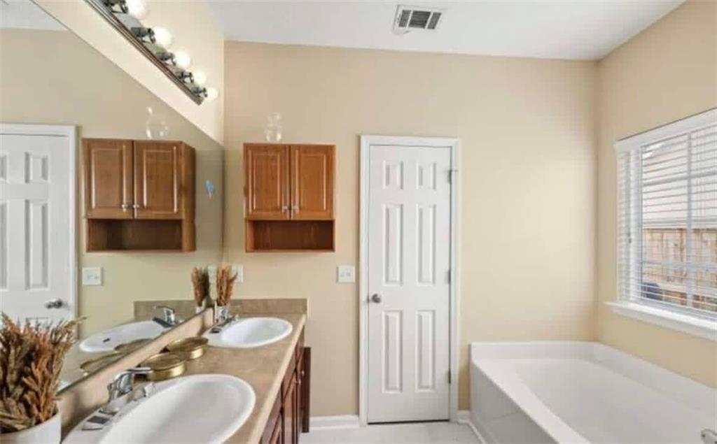 2162 Capella Circle Southwest Atlanta, GA 30331 - Photo 8 of 11 a bathroom with a granite countertop tub sink and mirror