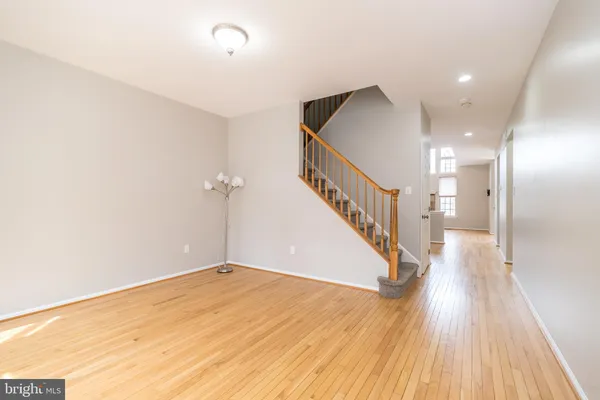 a view of a hallway with wooden floor