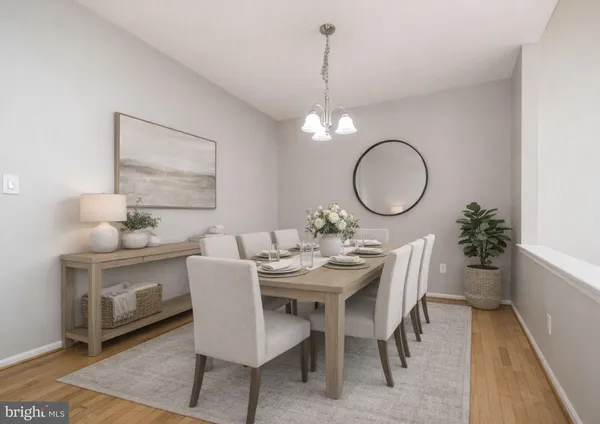 a view of a dining room with a table and chairs