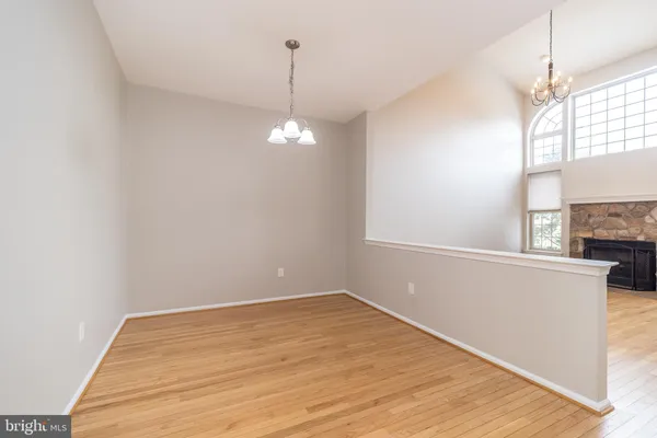 a view of a room with wooden floor and chandelier