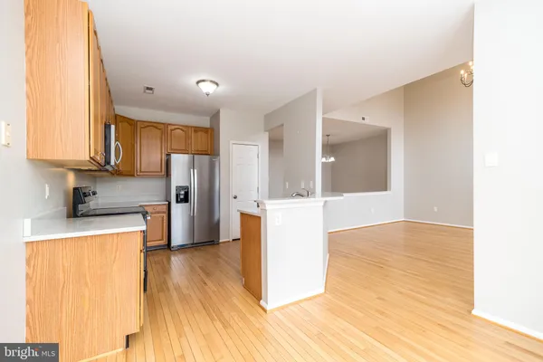 a kitchen with granite countertop white cabinets and black appliances