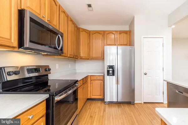 a kitchen with stainless steel appliances granite countertop a sink stove and microwave