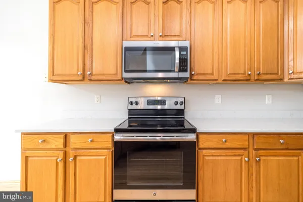 a view of a kitchen with a sink dishwasher and wooden floor
