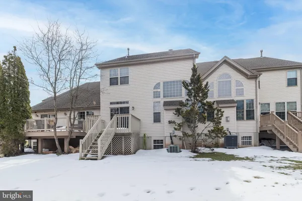 a view of a house with a snow in the background